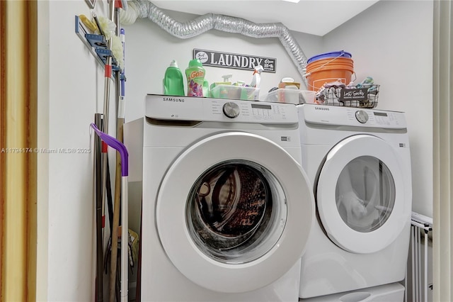 clothes washing area featuring washing machine and clothes dryer and laundry area