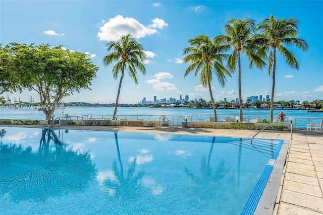 pool with a water view and fence