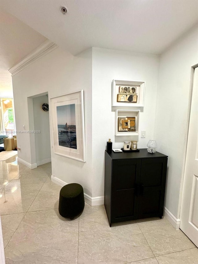 3001 NE 185th St Unit 225, Aventura, FL 33180 - hall with crown molding, baseboards, and light tile patterned floors