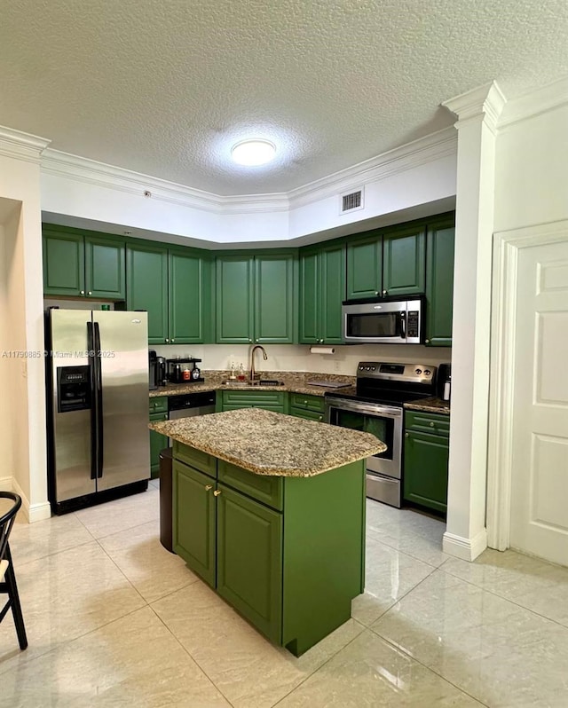 3001 NE 185th St Unit 225, Aventura, FL 33180 - kitchen featuring visible vents, crown molding, appliances with stainless steel finishes, a center island, and green cabinets
