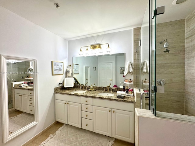 3001 NE 185th St Unit 225, Aventura, FL 33180 - bathroom with a sink, tile patterned floors, a tile shower, and double vanity
