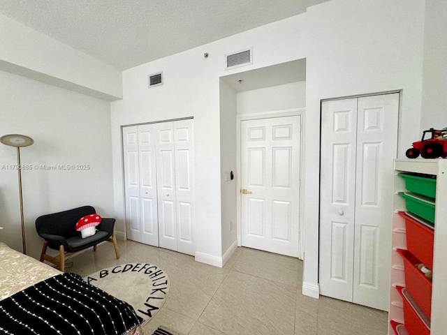 3001 NE 185th St Unit 225, Aventura, FL 33180 - bedroom featuring light tile patterned flooring, baseboards, and visible vents