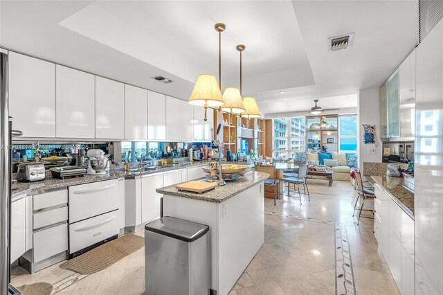 445 Grand Bay Dr Unit 1001, Key Biscayne, FL 33149 - kitchen featuring a raised ceiling, modern cabinets, a sink, white cabinets, and ceiling fan