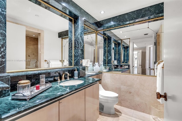 445 Grand Bay Dr Unit 1001, Key Biscayne, FL 33149 - bathroom featuring ornamental molding, toilet, tile patterned floors, vanity, and tile walls