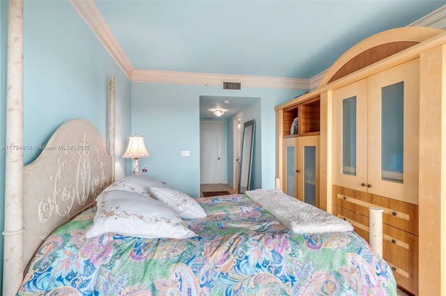 445 Grand Bay Dr Unit 1001, Key Biscayne, FL 33149 - bedroom with crown molding and a closet