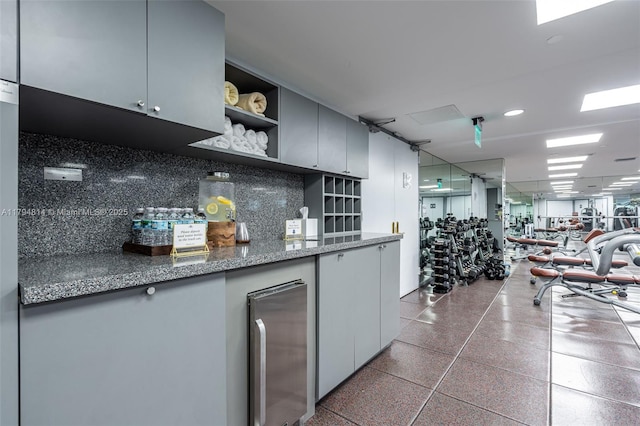 445 Grand Bay Dr Unit 1001, Key Biscayne, FL 33149 - kitchen featuring open shelves, stainless steel fridge, speckled floor, tasteful backsplash, and open floor plan