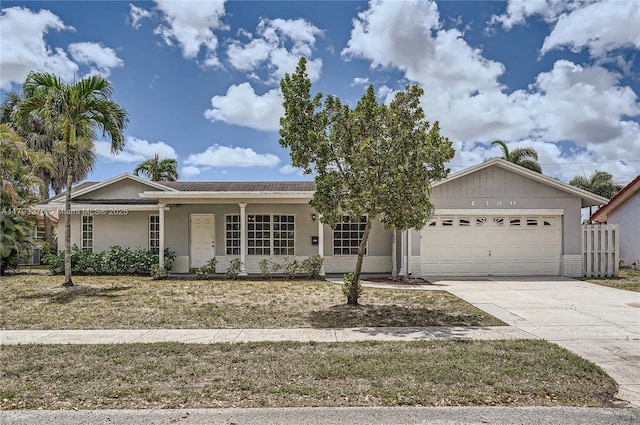 4380 NW 4th Ct, Coconut Creek, FL 33066 - ranch-style house with a garage, stucco siding, concrete driveway, and a porch