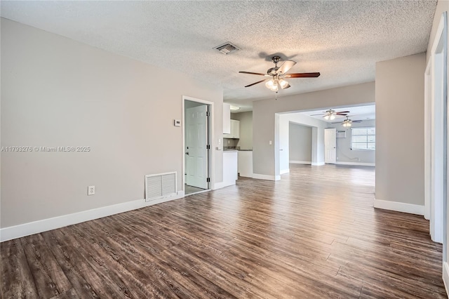 4380 NW 4th Ct, Coconut Creek, FL 33066 - unfurnished living room with a ceiling fan, baseboards, visible vents, and dark wood-style floors