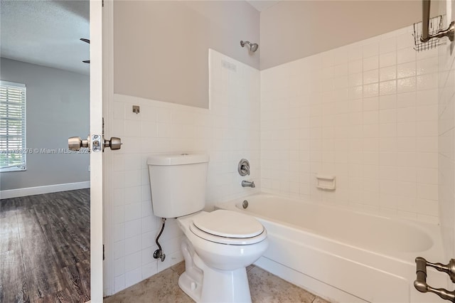 4380 NW 4th Ct, Coconut Creek, FL 33066 - full bathroom with shower / bathing tub combination, a wainscoted wall, toilet, and tile walls