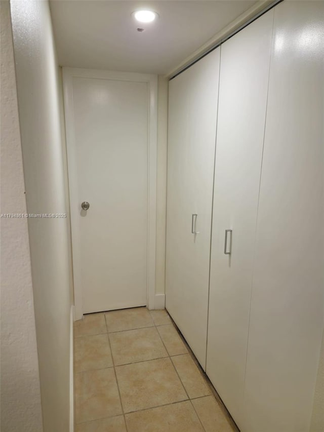 hallway featuring light tile patterned floors and recessed lighting