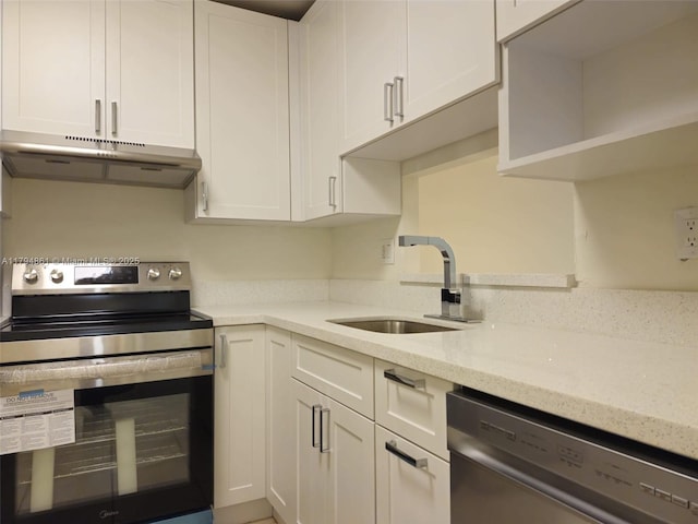 kitchen with white cabinets, light stone countertops, a sink, stainless steel appliances, and under cabinet range hood