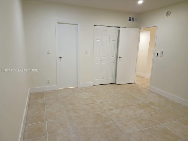 unfurnished bedroom featuring visible vents, light tile patterned floors, baseboards, a closet, and recessed lighting