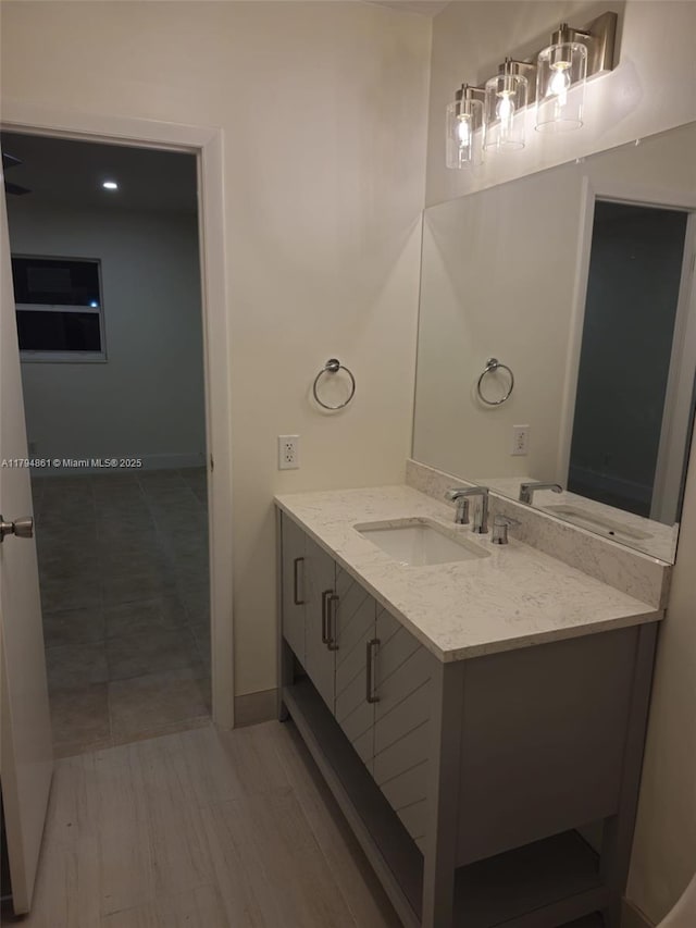 bathroom featuring vanity and baseboards