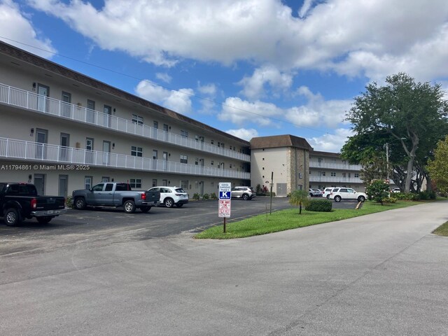 view of building exterior featuring uncovered parking