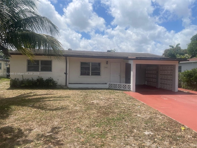 single story home featuring an attached garage, a front lawn, stucco siding, and concrete driveway