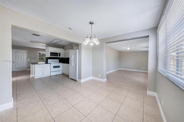 6808 SW 22nd Ct, Miramar, FL 33023 - unfurnished dining area featuring healthy amount of natural light, a chandelier, light tile patterned floors, and baseboards