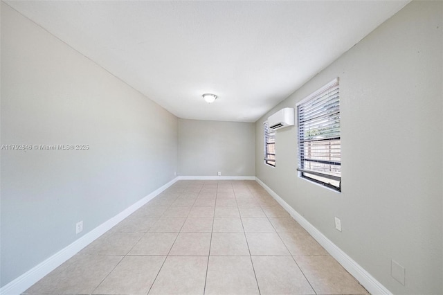 6808 SW 22nd Ct, Miramar, FL 33023 - spare room with an AC wall unit, light tile patterned floors, and baseboards