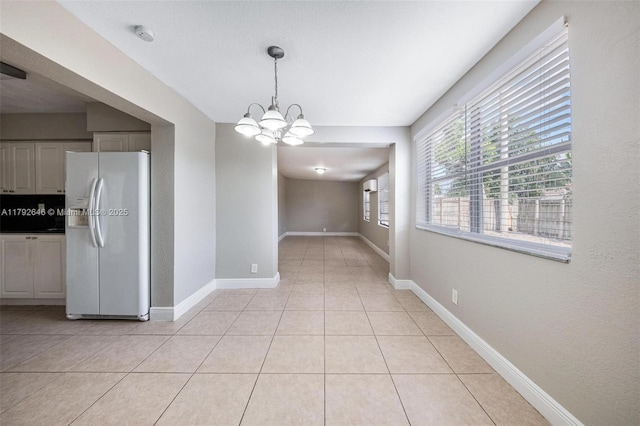6808 SW 22nd Ct, Miramar, FL 33023 - unfurnished dining area with a chandelier, light tile patterned floors, and baseboards