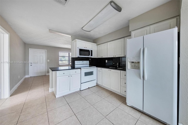 6808 SW 22nd Ct, Miramar, FL 33023 - kitchen with white appliances, dark countertops, and light tile patterned floors