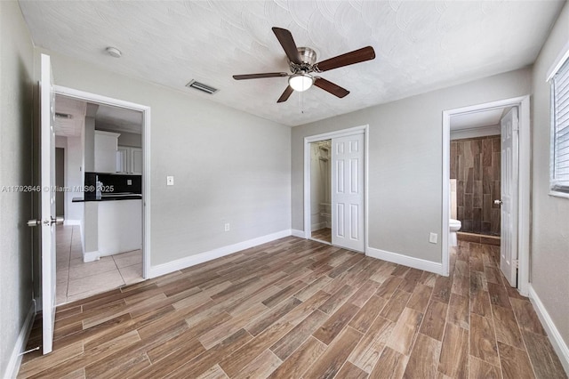 6808 SW 22nd Ct, Miramar, FL 33023 - unfurnished bedroom featuring light wood-style flooring, baseboards, ensuite bath, and a closet