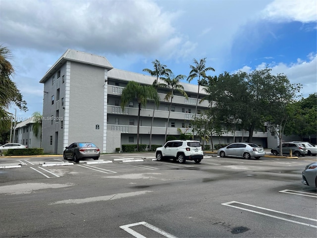 view of building exterior with uncovered parking