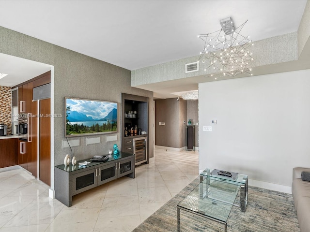 living area featuring a chandelier, visible vents, and wine cooler