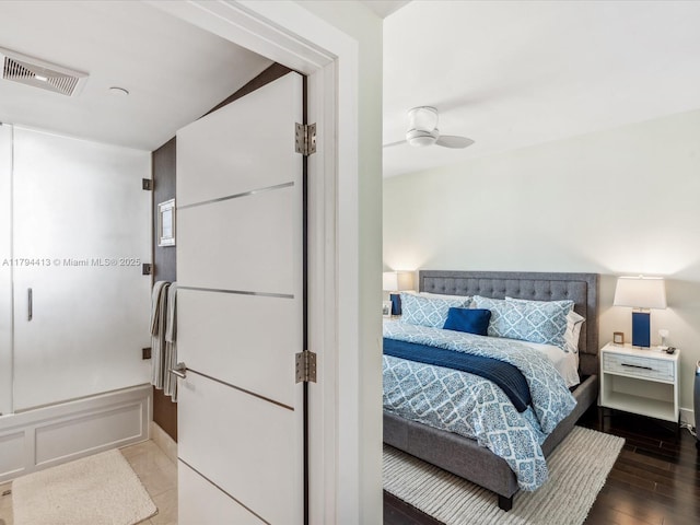 bedroom with visible vents and wood finished floors
