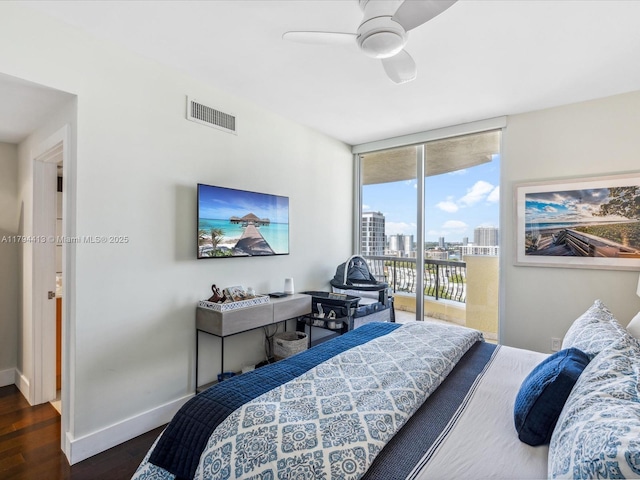 bedroom featuring access to outside, dark wood finished floors, baseboards, floor to ceiling windows, and visible vents