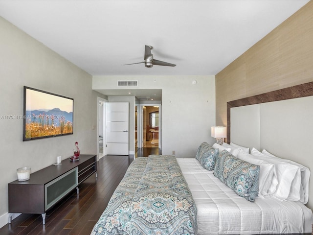 bedroom with baseboards, ceiling fan, visible vents, and wood finished floors