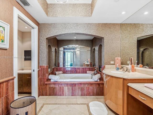 full bathroom featuring tile patterned flooring, vanity, visible vents, a garden tub, and a stall shower