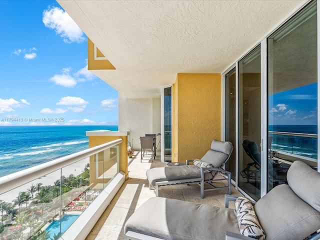 balcony with an outdoor living space and a water view