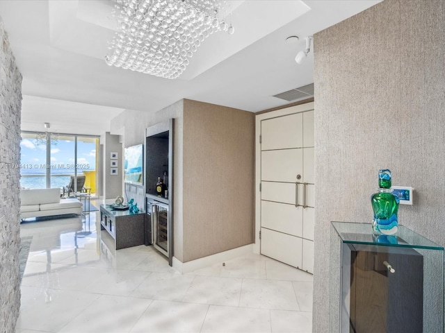 interior space featuring a water view, beverage cooler, and visible vents
