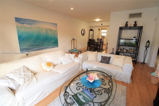living area featuring recessed lighting, wood finished floors, and visible vents
