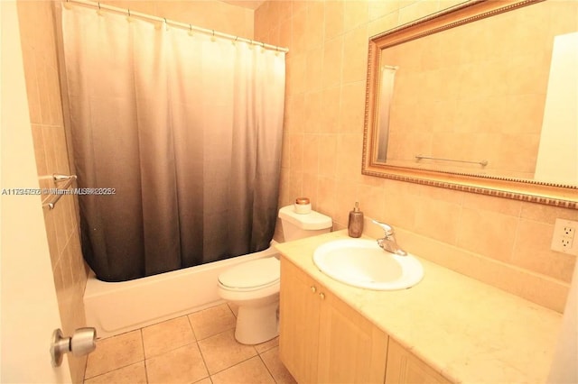 bathroom featuring vanity, toilet, tile patterned floors, tile walls, and backsplash