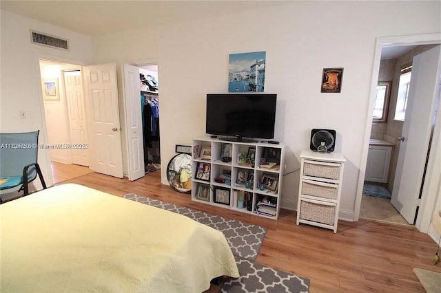 9260 Bay Harbor Ter Unit 22, Bay Harbor Islands, FL 33154 - bedroom with visible vents, wood finished floors, a spacious closet, and a closet