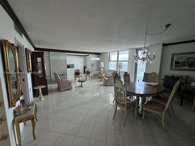 dining room with a textured ceiling, an inviting chandelier, ornamental molding, and light tile patterned floors