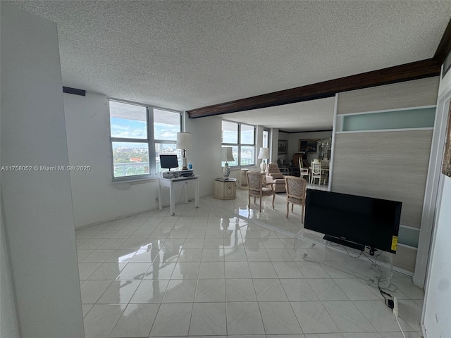 living room featuring beam ceiling and a textured ceiling