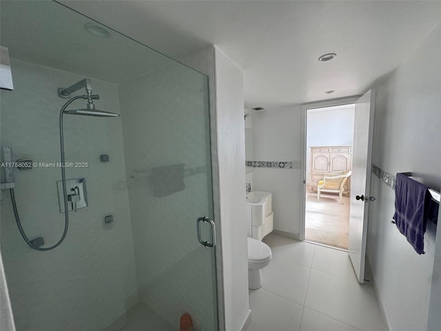 bathroom with tile patterned floors, toilet, and a shower stall