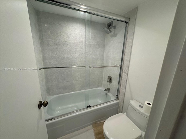full bathroom with shower / bath combination with glass door and toilet