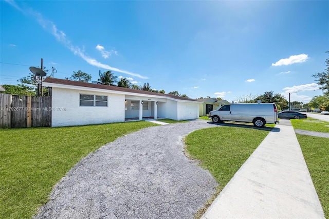 6620 NW 21st Ct, Sunrise, FL 33313 - ranch-style house featuring fence, a garage, a front yard, and aphalt driveway