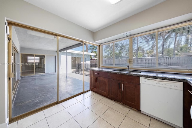 6620 NW 21st Ct, Sunrise, FL 33313 - kitchen with dark brown cabinets, a sink, dishwasher, dark stone counters, and light tile patterned floors