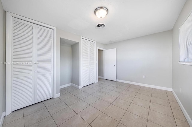 6620 NW 21st Ct, Sunrise, FL 33313 - unfurnished bedroom featuring baseboards, light tile patterned flooring, and visible vents