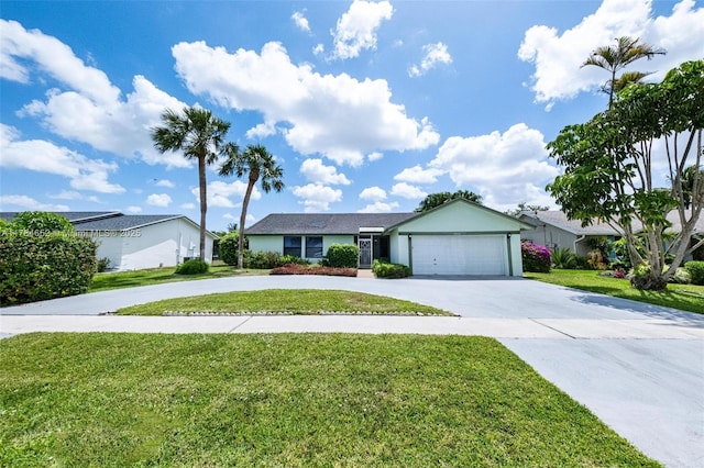 single story home with an attached garage, curved driveway, and a front yard