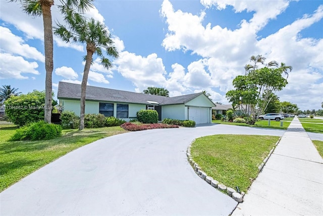 ranch-style house with curved driveway, an attached garage, stucco siding, and a front lawn