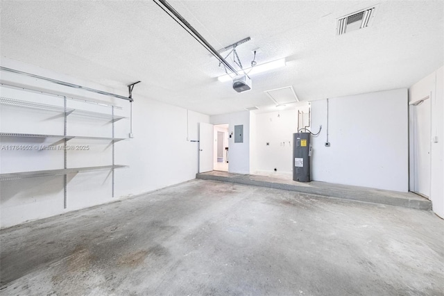 garage featuring visible vents, a garage door opener, electric panel, and electric water heater