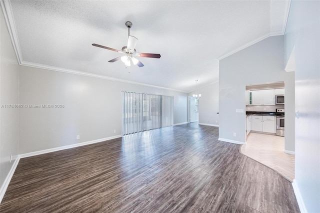 unfurnished living room featuring crown molding, ceiling fan with notable chandelier, baseboards, wood finished floors, and vaulted ceiling
