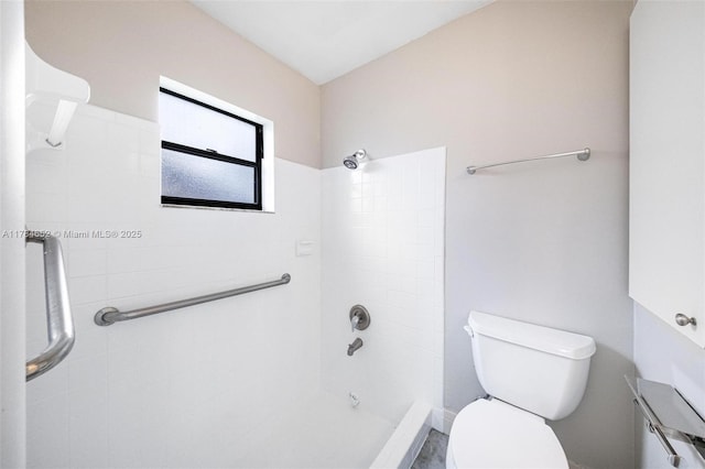 bathroom featuring a shower and toilet