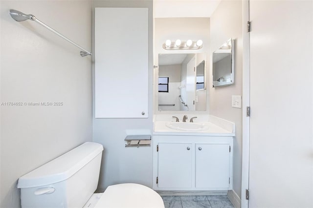 bathroom with vanity, marble finish floor, and toilet