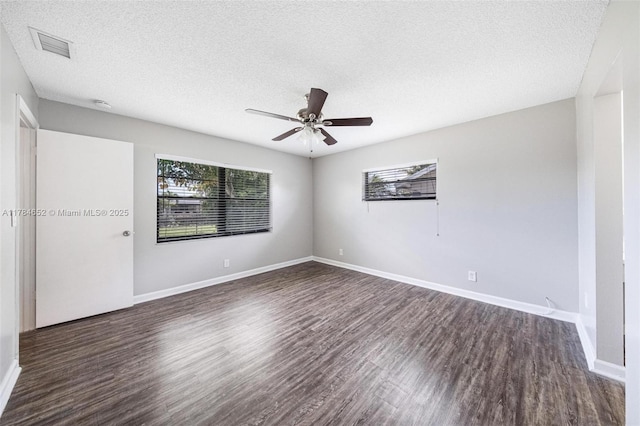 unfurnished room with baseboards, a ceiling fan, a textured ceiling, and wood finished floors