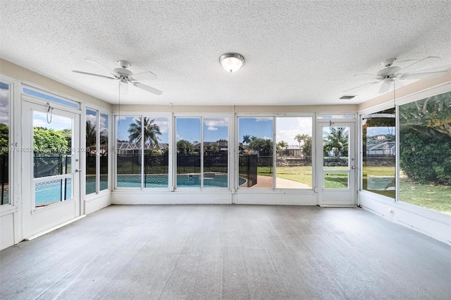 unfurnished sunroom featuring a ceiling fan and visible vents